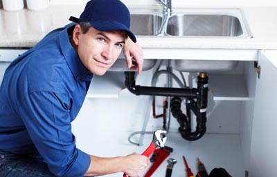 Plumber replacing a kitchen sink.